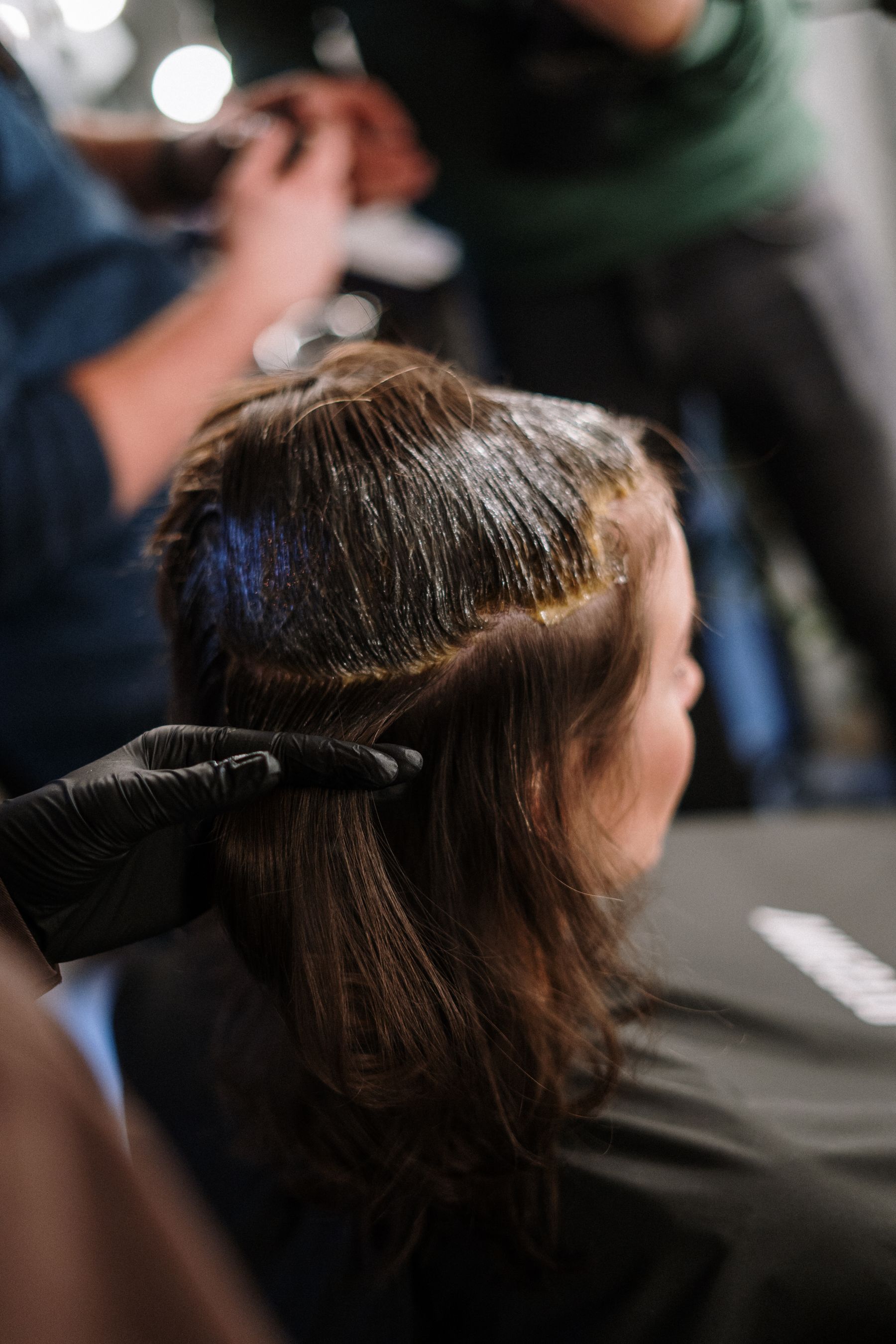 Client having hair colour applied in a salon